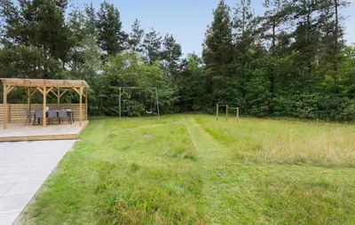 a gazebo with a picnic table in a field at Nice Home In Højslev With Kitchen in Højslev