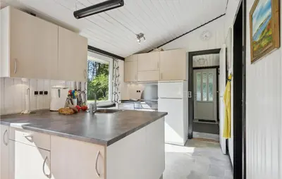 a kitchen with white cabinets and a counter top at Nice Home In Højslev With Kitchen in Højslev