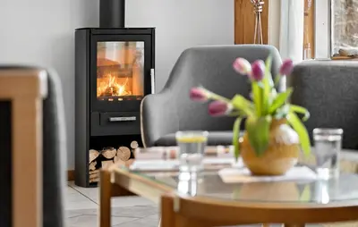 a living room with a couch and a fireplace at Holiday Home Illeris Farsø Vi in Farsø