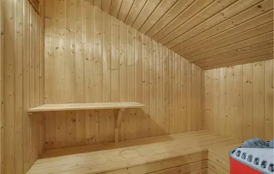 a wooden sauna with a shelf in the corner at Holiday Home Bavnbak Thisted Iv in Thisted