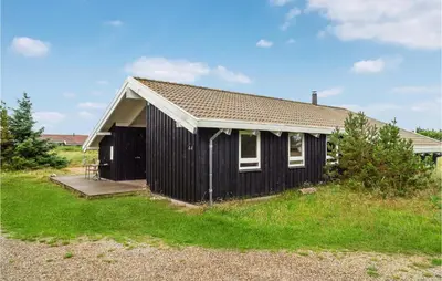 a black and white house with a porch at Holiday Home Bavnbak Thisted Iv in Thisted