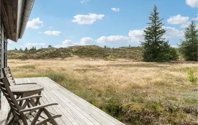 a wooden deck with a chair on top of a field at Nice Home In Fjerritslev With Wifi in Fjerritslev