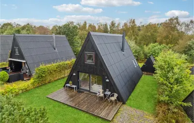 an aerial view of a black house with a deck at Gorgeous Home In Farsø With Kitchen in Farsø
