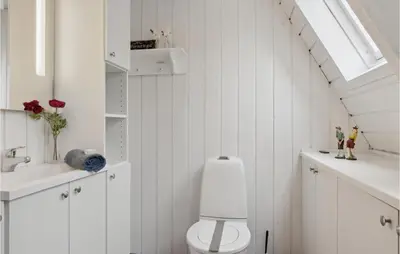 a white bathroom with a toilet and a sink at Gorgeous Home In Farsø With Kitchen in Farsø