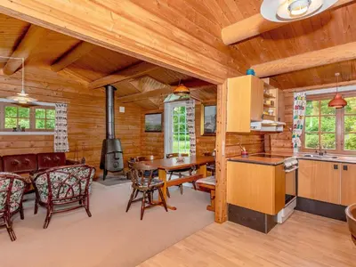 a kitchen and dining room with a table and a stove at 6 person holiday home in Roslev-By Traum in Roslev