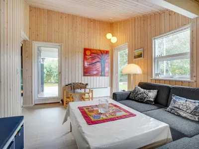 a living room with a couch and a table at Holiday Home Ønder - 800m from the sea by Interhome in Blokhus