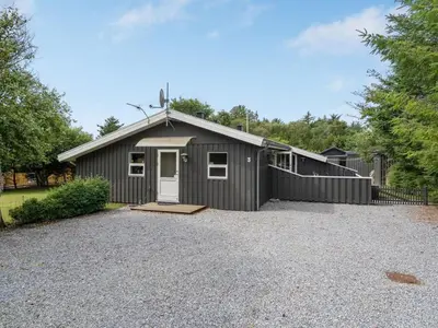 a gray garage with a gravel driveway at Holiday Home Ønder - 800m from the sea by Interhome in Blokhus