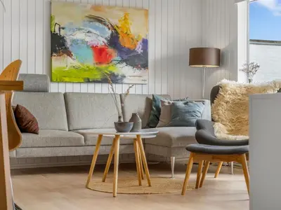 a living room with a couch and a table at Holiday Home Tarvo - 400m from the sea by Interhome in Pandrup