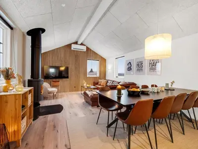 a living room with a dining table and a living room at Holiday Home Ivar - 300m from the sea by Interhome in Harboør