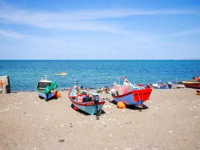 a group of boats sitting on the beach at Holiday Home Ilkka - 400m from the sea by Interhome in Torsted
