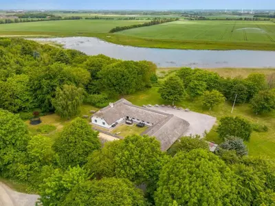 an overhead view of an old house in the woods next to a river at Holiday Home Tatiane - 10km from the sea by Interhome in Bækmarksbro