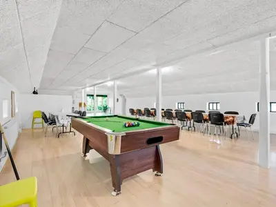 a billiard room with a pool table and chairs at Holiday Home Tatiane - 10km from the sea by Interhome in Bækmarksbro