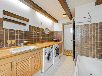 a laundry room with a sink and a washing machine at Holiday Home Tatiane - 10km from the sea by Interhome in Bækmarksbro