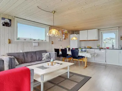 a living room with a couch and a table at Holiday Home Ormar - 100m to the fjord by Interhome in Lemvig