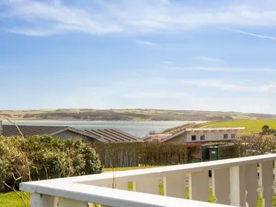 a view of the water from the balcony of a house at Holiday Home Ormar - 100m to the fjord by Interhome in Lemvig