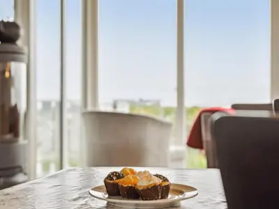 a plate of cupcakes sitting on a table at Holiday Home Ormar - 100m to the fjord by Interhome in Lemvig
