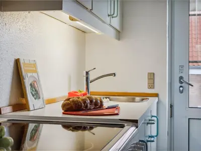 a kitchen with a sink and a plate of food on a counter at Holiday Home Ubbe - 200m from the sea by Interhome in Lemvig