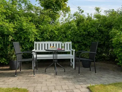 two chairs and a table with a white bench at Apartment Dietlinde - 1-3km to the fjord by Interhome in Thyholm