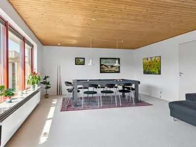 a dining room with a table and chairs at Holiday Home Ingward - 750m from the sea by Interhome in Vestervig