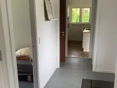 a hallway with a room with a bed and a window at Holiday Home Bjerne - 250m to the fjord by Interhome in Roslev