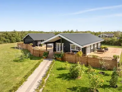 a house with a garden in front of it at Holiday Home Gizella - 500m to the fjord by Interhome in Spottrup