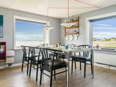 a dining room with a table and black chairs at Holiday Home Swaantje - 150m to the fjord by Interhome in Fur
