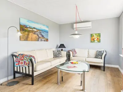 a living room with a couch and a table at Holiday Home Swaantje - 150m to the fjord by Interhome in Fur
