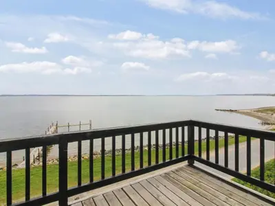 a view of the water from the balcony of a house at Holiday Home Sander - 10m to the fjord by Interhome in Roslev