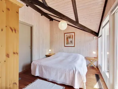 a bedroom with a white bed and a window at Holiday Home Alban - 700m from the sea by Interhome in Løkken