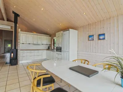 a kitchen with a white table and chairs at Holiday Home Ran - 1-5km from the sea by Interhome in Saltum
