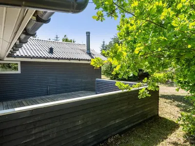 a house with a retaining wall and a fence at Holiday Home Aneline - 700m from the sea by Interhome in Saltum
