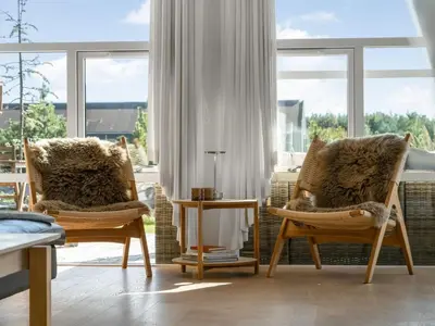 a living room with two chairs and a window at Holiday Home Sazdo - 1-1km from the sea by Interhome in Saltum