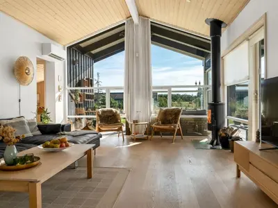 a living room with a couch and a fireplace at Holiday Home Sazdo - 1-1km from the sea by Interhome in Saltum