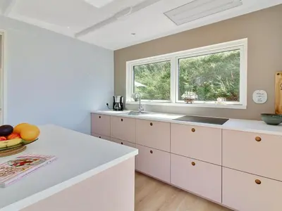 a kitchen with white cabinets and a window at Holiday Home Hoat - 300m from the sea by Interhome in Saltum