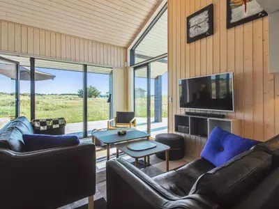 a living room with couches and a tv at Holiday Home Ascan - 600m from the sea by Interhome in Løkken