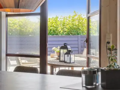 a table with a coffee maker on a table on a patio at Holiday Home Fridgerd - 250m from the sea by Interhome in Blokhus