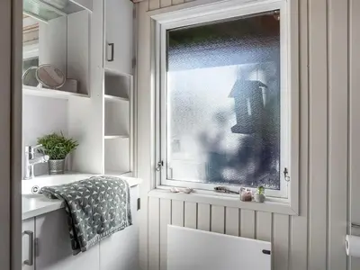 a bathroom with a window and a sink at Holiday Home Apsolon - 600m from the sea by Interhome in Løkken