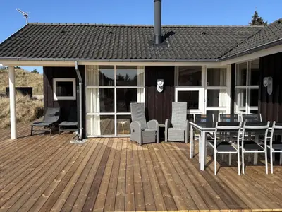 a deck with chairs and a table on a house at Holiday Home Franzisca - 700m from the sea by Interhome in Saltum