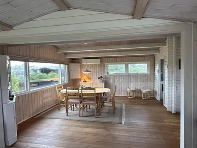 a dining room with a table and chairs at Holiday Home Freding - 450m from the sea by Interhome in Løkken