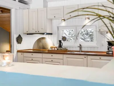 a kitchen with white cabinets and a sink at Holiday Home Valda - 1-5km from the sea by Interhome in Saltum