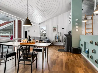 a kitchen and living room with a table and chairs at Holiday Home Valda - 1-5km from the sea by Interhome in Saltum