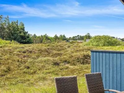 two chairs sitting on top of a grassy hill at Holiday Home Henri - 500m from the sea by Interhome in Fjerritslev