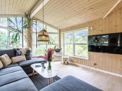 a living room with a couch and a table at Holiday Home Arlett - 950m from the sea by Interhome in Fjerritslev
