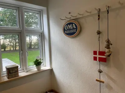 a room with two windows and a sign on the wall at Thyholm B&B in Thyholm
