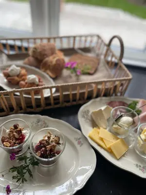 a table with plates of food and a basket of food at Thyholm B&B in Thyholm