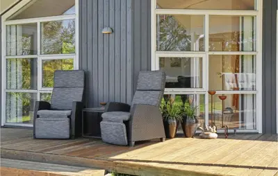 two chairs and a table on a front porch at Amazing Home In Vestervig With Kitchen in Vestervig