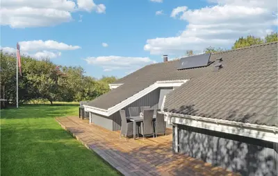 a roof of a house with a table and chairs at Amazing Home In Vestervig With Kitchen in Vestervig
