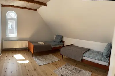 a attic room with two beds and a window at Apartment Vanilla - 2 rooms and one bathroom in Struer