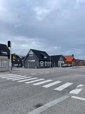 an empty street with a crosswalk in front of houses at Apartment Vanilla - 2 rooms and one bathroom in Struer
