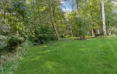 a yard with green grass and trees at Awesome Home In Nykøbing M in Hesselbjerg